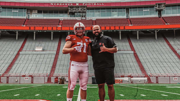 Jake Peters with Nebraska offensive line coach Donovan Raiola